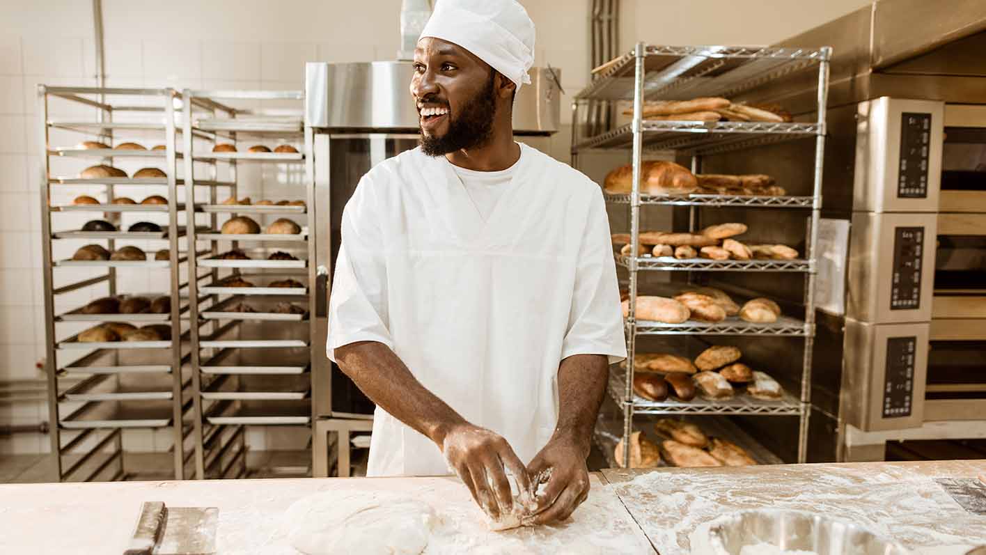 Baker preparing raw dough for pastry 