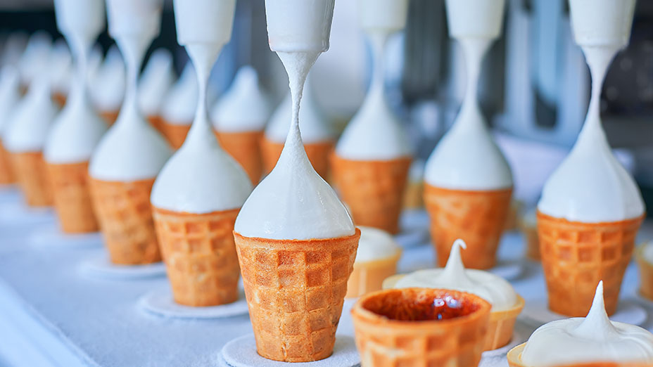 Conveyor belt with icecream cones at a modern food processing factory