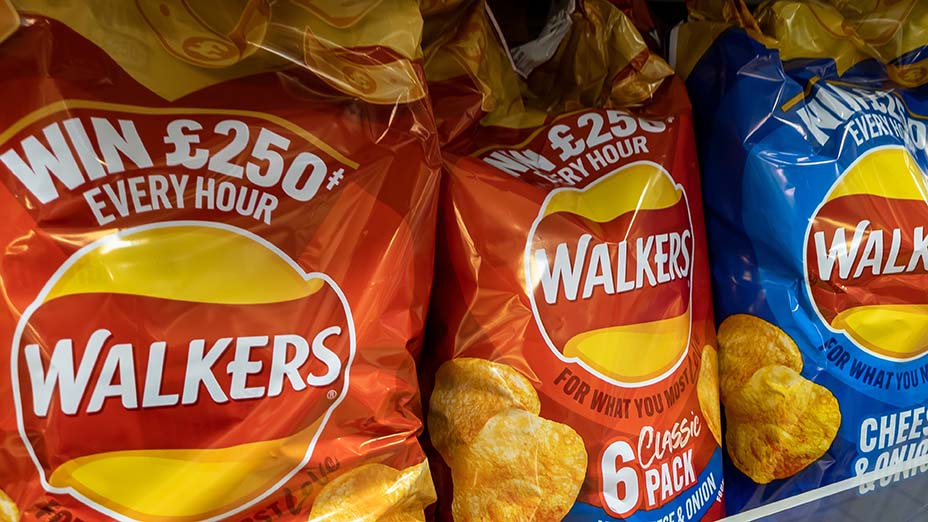 kets of potato crisps on display on a supermarket shelf