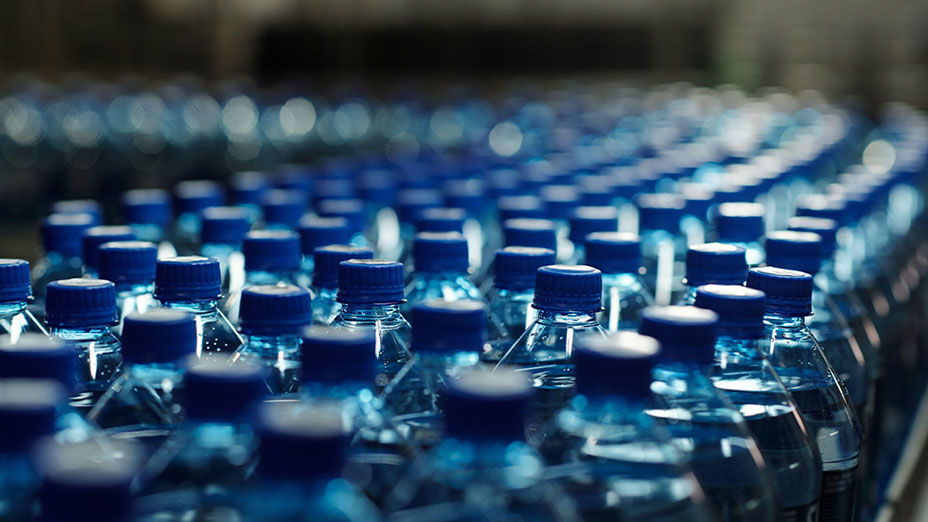 Blue bottles on production line